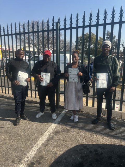 Four learners holding their licences
