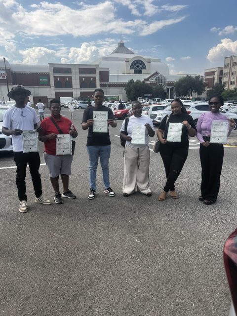 Six learners holding their new licences